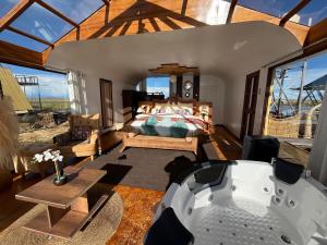 a room with a bath tub and a bedroom at TiticacaMarkaLodge in Puno