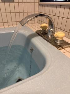 a bath tub with a water faucet in a bathroom at はなれ香 in Kirishima +41 photos