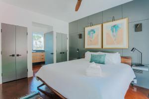 a bedroom with a large white bed with blue walls at Art & Soul in Lyndhurst