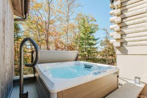 a hot tub sitting on a patio with a window at Art & Soul in Lyndhurst