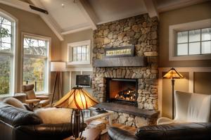 a living room with a stone fireplace at Art & Soul in Lyndhurst +47 photos