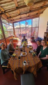 a group of people sitting around a long table at Pumaexplorer in Urubamba +22 photos