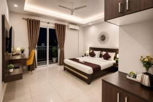 a bedroom with a bed and a large window at Kailashi Hotel Har ki pauri in Haridwār