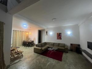 a living room with a couch and a table at D&D Holyday Homes in Kandy