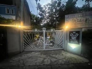 a bike parked behind a gate at night at D&D Holyday Homes in Kandy