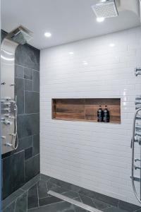 a bathroom with a shower with two bottles on a shelf at Prescott Mountain Luxury Escape! in Prescott