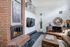 a living room with a brick fireplace and a couch at Prescott Mountain Luxury Escape! in Prescott