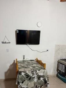 a dining room table with a television on a wall at Nat depto in Senillosa