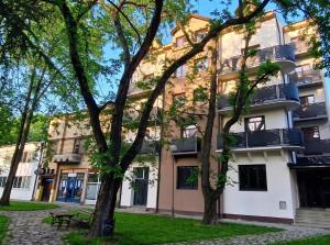 a building with trees in front of it at ParkNest - Apartmani i sobe in Apatin