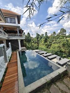a swimming pool in the backyard of a house at Nawang Sakti in Ubud