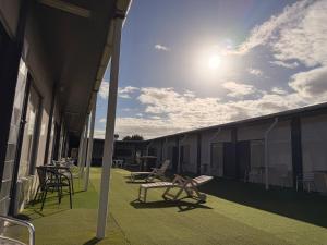 a patio with chairs and tables on a building at Top1Capricorn in The Range