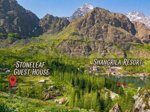a view of a valley with mountains and a town at Stone Leaf Retreat - Skardu in Skardu