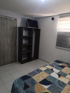a bedroom with a bed and a book shelf at Departamento faja de oro in Salamanca