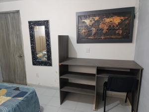 a bedroom with a desk and a mirror and a bed at Departamento faja de oro in Salamanca +2 photos