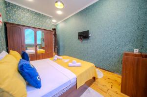 a bedroom with a bed and a tv on a wall at Gabala Garden Harmony in Gabala