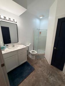 a bathroom with a sink and a toilet and a mirror at Cedar Studios at Whitetail Estates in Babbitt +8 photos