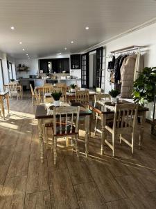a dining room with a table and chairs and a kitchen at Gemstone Guest House in Klerksdorp
