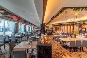 a restaurant with tables and chairs in a room at NU Hotel in Bintulu