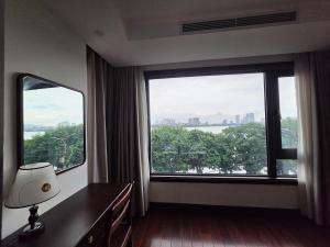 a hotel room with a large window with a view at Lakeside Retreat - Tay Ho in Hanoi