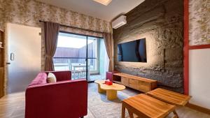 a living room with a couch and a tv at C Family Hotel in Citeureup 1
