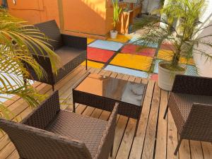 an outdoor patio with chairs and a table with a colorful rug at Music Guest House in Mexico City