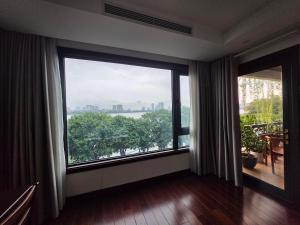 a room with a large window with a view of the city at Lakeside Retreat - Tay Ho in Hanoi +15 photos