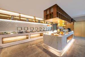a kitchen with a counter with food on it at Atour Hotel Lanzhou Xigu in Lanzhou