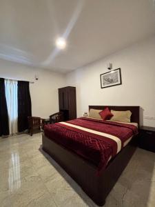 a bedroom with a large bed in a room at Green woods stays in Ooty