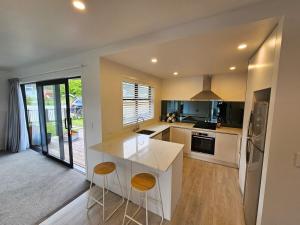 a kitchen with a white counter top in a room at Stylish townhouse in Te Aroha
