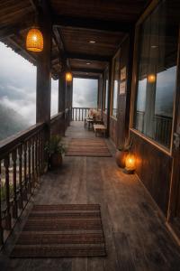 a porch of a house with a view of the mountains at Ơ MÂY ZING Homestay in Bắc Yên
