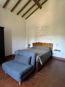 a bedroom with a bed and a couch at Agriturismo Podere Sant' Antonio in Alberese