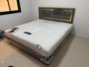 a bed sitting in a corner of a room at 786ResortSungaiGolok in Kampong Baka