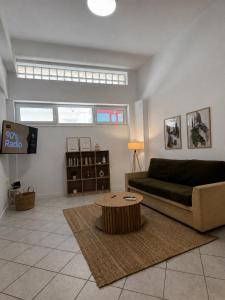 a living room with a couch and a coffee table at Tailor Urban Loft Thiva in Thiva