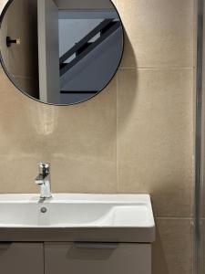 a bathroom with a sink and a mirror at Tailor Urban Loft Thiva in Thiva
