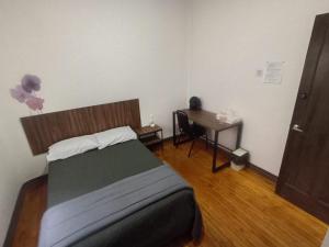 a bedroom with a bed and a wooden floor at Hostal Schultz in Mexico City +8 photos