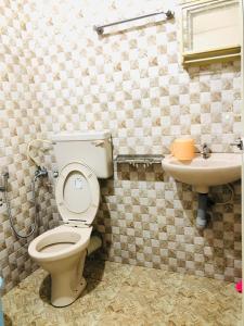 a bathroom with a toilet and a sink at Sheeba's Homestay in Cochin +14 photos