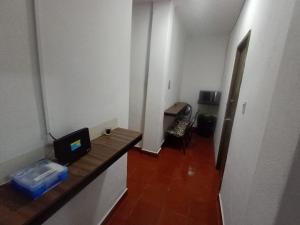 a small room with a desk with a laptop on it at Hostal Schultz in Mexico City