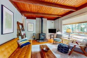 a living room with a couch and a fireplace at Wooded-View Decks: Family Cabin Retreat in Deming in Warnick