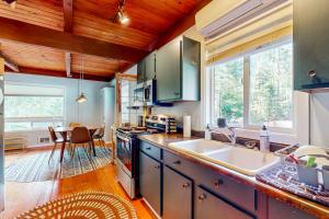 a kitchen with a sink and a counter top at Wooded-View Decks: Family Cabin Retreat in Deming in Warnick