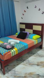 a bedroom with a bed with blue curtains at Los Clemones in Rincón