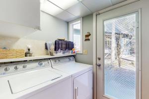 a kitchen with a washing machine and a window at Wooded-View Decks: Family Cabin Retreat in Deming in Warnick +17 photos