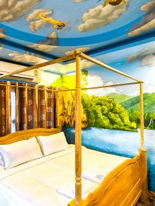 a bedroom with a bed with a painting on the ceiling at Thongtara House Boutique Srinakarin in Bangkok +208 photos