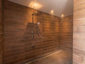 a bathroom with a shower with wooden walls at 水杜のすみか大野屋 in Fukui +37 photos