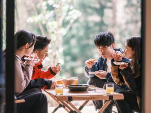 a group of people sitting at a table eating food at 水杜のすみか大野屋 in Fukui