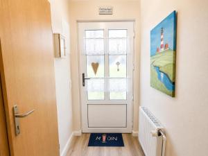 a door with a sign in front of a window at Kleine Meereskrabbe in Werdum