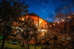 a house lit up at night with lights at The Raarees Mist Resort, Munnar - Nested in Nature's Lap in Munnar
