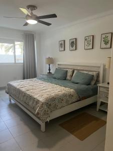 a bedroom with a bed and a ceiling fan at STEPS TO THE BEACH 2 Stunning condo 4 min walk to Bibijagua Beach and Catamarans in Punta Cana +52 photos