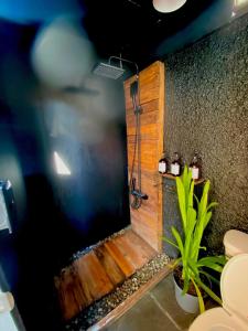 a bathroom with a shower with a wooden wall at Music Guest House in Mexico City