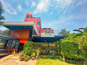 a colorful building with plants in front of it at Thongtara House Boutique Srinakarin in Bangkok