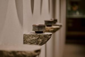 a close up of two faucets on a wall at 穴吹邸 / ANABUKI-TEI in Takamatsu +15 photos